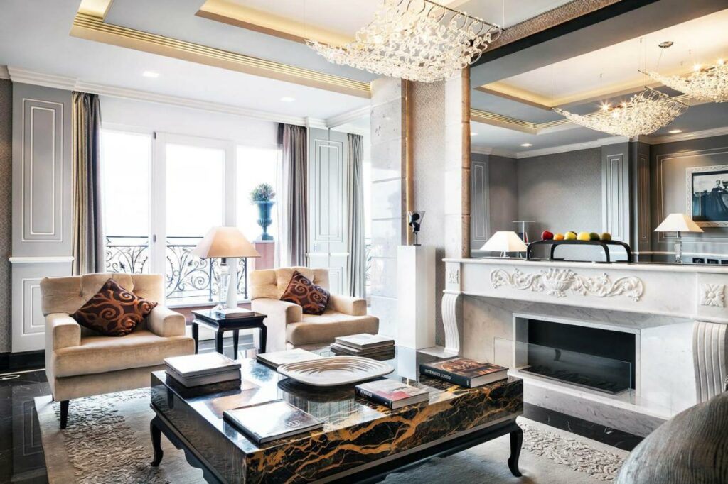 Elegant hotel room featuring a fireplace and a stunning chandelier.