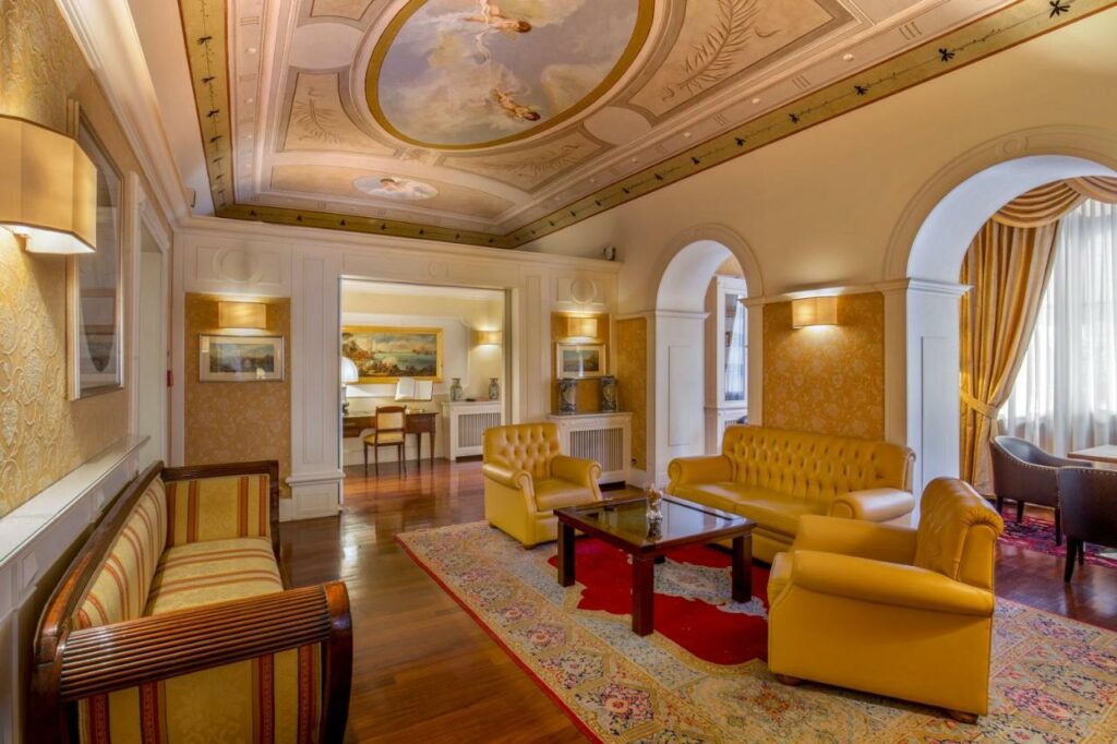 Luxurious hotel sitting area with a stunning gold-painted ceiling.