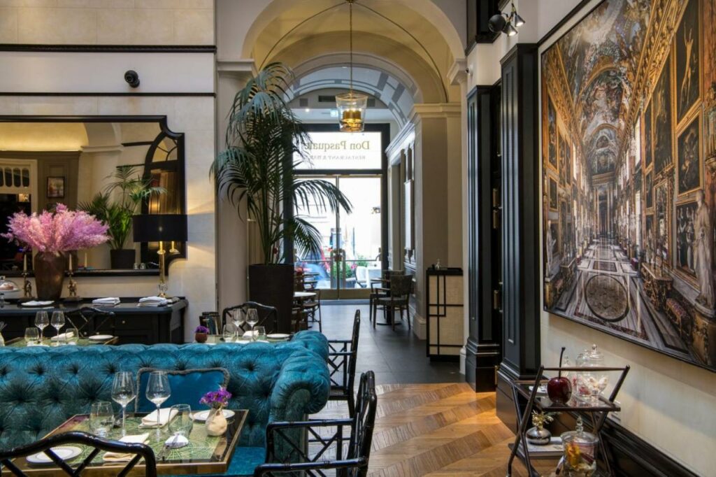 Beautiful lobby bar with mirror and big wall painting, palm tree