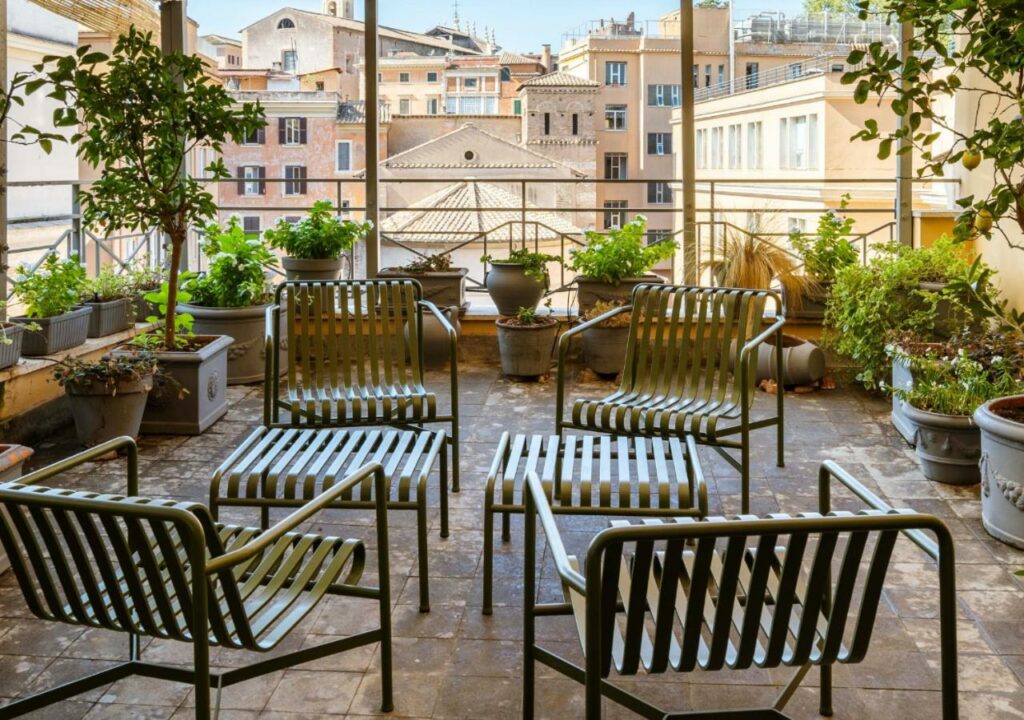 Beautiful terrace of the Condominio Monti Boutique Hotel with lots of plants and city view