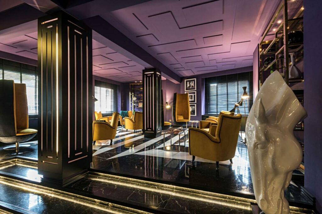 Elegant hotel lobby with purple and black theme.