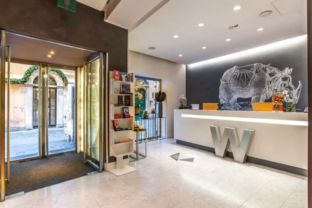 A nicely decorated lobby with a rhinoceros drawing on the reception wall.