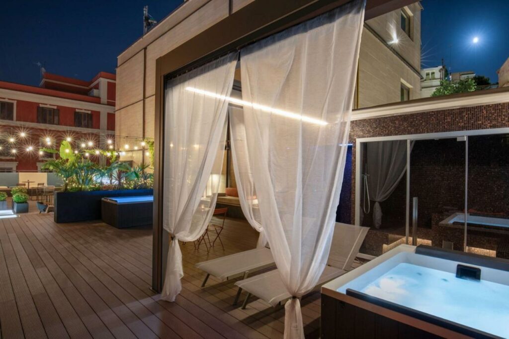 A rooftop hot tub at night, providing a relaxing and luxurious experience.