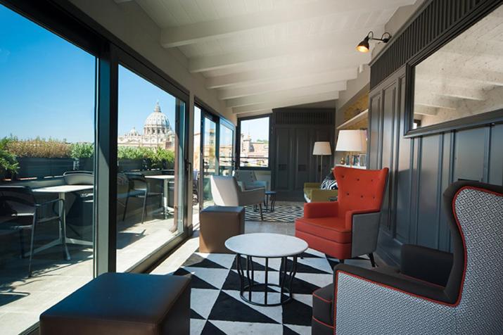 A modern hotel relaxation area with a panoramic city view through large windows.