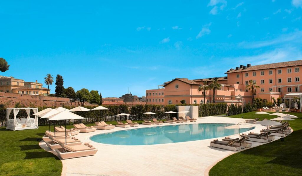 Luxurious pool at Villa Agrippina Gran Meliá, surrounded by elegant lounge chairs.